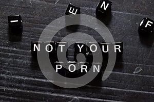 Not Your Porn on wooden cubes. On table background