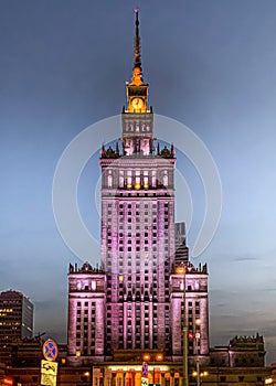 Notable illuminated Palace of Culture and Science high-rise building in Warsaw, Poland at night