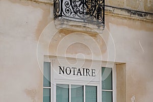 Notaire french text sign means notary in wall windows building entrance agency office photo