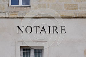 Notaire french text sign means office entrance notary sign in wall building photo