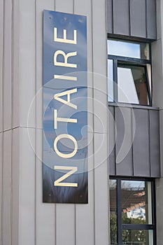 Notaire sign french board on wall notary office photo