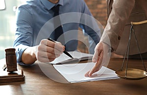 Notaries working with papers at table in office. Law and justice concept photo