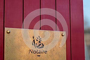 Notary board sign golden logo entrance building office for french Notaire photo