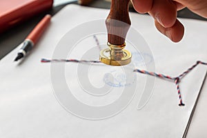 Notary public wax stamper. White envelope with brown wax seal, golden stamp. Responsive design mockup, flat lay. Still life with