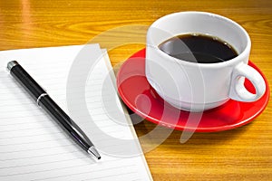 Note book and cup of coffee