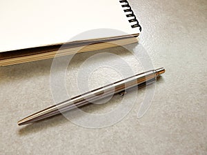 Note book with many color of pen on gray background