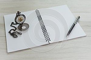 Note book opening white blank page with pen and vintage pocket w