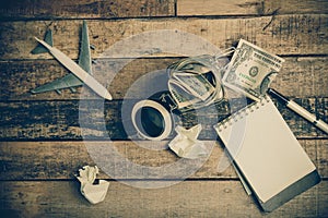 Note book paper on old wooden background ; still life.