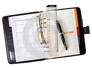 Note book paper with pen and glasses