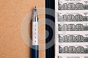 Note book, pen and dollars