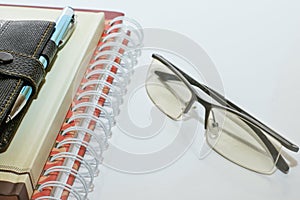 Note book pen and glasses