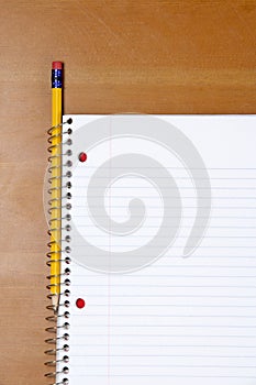 A note book and pencil on a desk