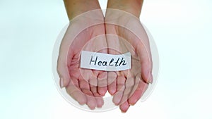 Note Health in female hands on a white background