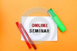 A note with the inscription Online seminar. A type of web conferencing, holding online meetings or presentations over the Internet