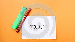 A note with the inscription Trust and a markers. Trust relationships between business partners, friends, relatives. Respect and