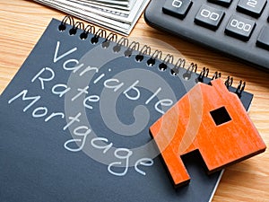 Note with inscription variable rate mortgage VRM and model of house.