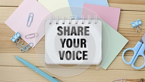 note with the message of share your voice,