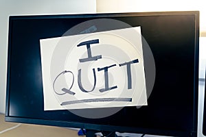 Note on a monitor of a work computer with the text I QUIT. Great resignation concept photo
