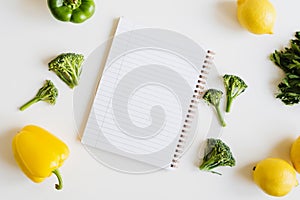 Note pad with blank pages and fresh vegetables and fruits on white background