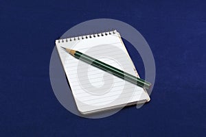 Note pad with green pencil