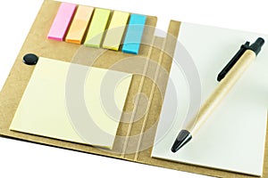 Note pad with pen on white background