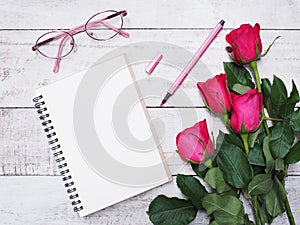 Note pad pink with eyeglases and roses. photo