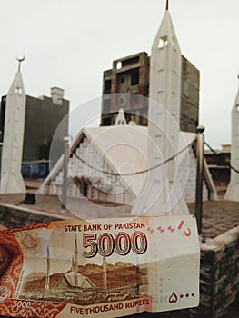 5000 note Pakistani ruppe currency with shah Faisal Masjid Islamabad photo