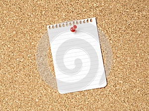 A note paper on a corkboard with red pushpin