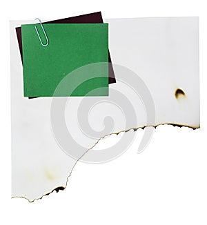 Note paper and paper clip on white paper burn