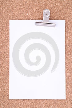 Note Paper With Paperclip On Cork Surface