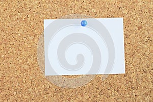 Note paper pined on cork board background