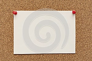 Note paper swith push pins on cork board. Empty paper pages for notes copy space
