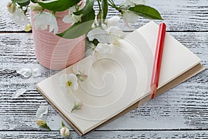 Note, postcard, writing blossoms on a wooden vintage table. Spring pink flowers.