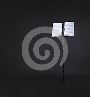 Note stand with music sheets on black. Space for text