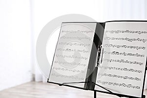 Note stand with music sheets indoors.