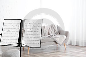Note stand with music sheets indoors