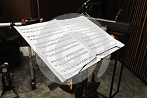 Note stand with music sheets at recording studio. Band practice