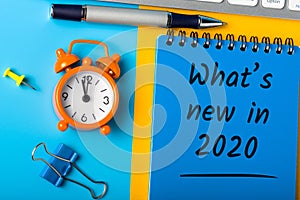 A note What`s new in 2020 year. Changes coming in 2020. With office or school supplies