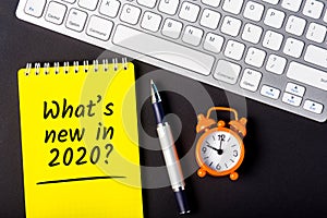 A note What`s new in 2020 year. Changes coming in 2020. With office or school supplies