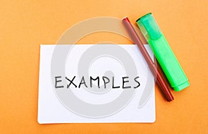 Note with the word Examples and markers. Example, instance, sample. Business, marketing and training concept. Flat lay
