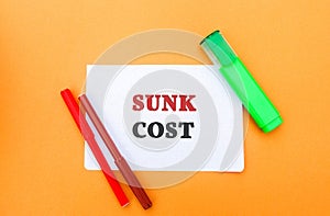 Note with words Sunk cost - retrospective cost and markers. Costs that cannot be recovered. Business and finance concept