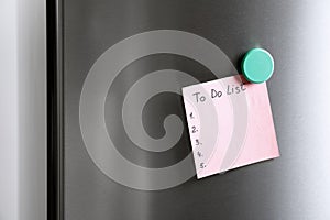 Note with words TO DO LIST on refrigerator door.