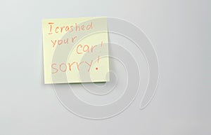 Note on yellow sticker paper sheets with words i crashed your car sorry.