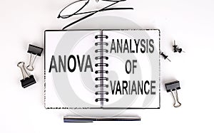 Notebook with ANOVA ANALYSIS OF VARIANCE on a table