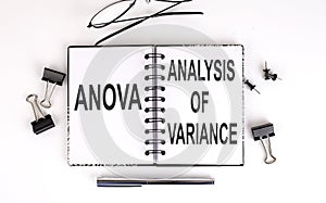 Notebook with ANOVA ANALYSIS OF VARIANCE on a table photo