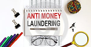 Notebook with Anti-money laundering AML on a table