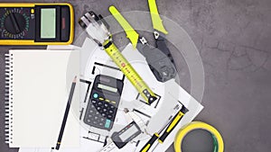 Notebook appear on table with construction tools and plans. Stop motion