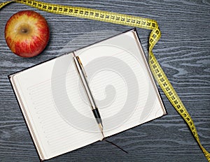 Notebook and apple