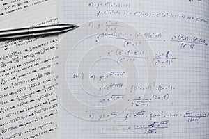 Notebook and book with mathematics equations and functions
