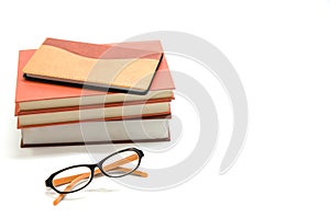 Notebook,books and glasses on white background